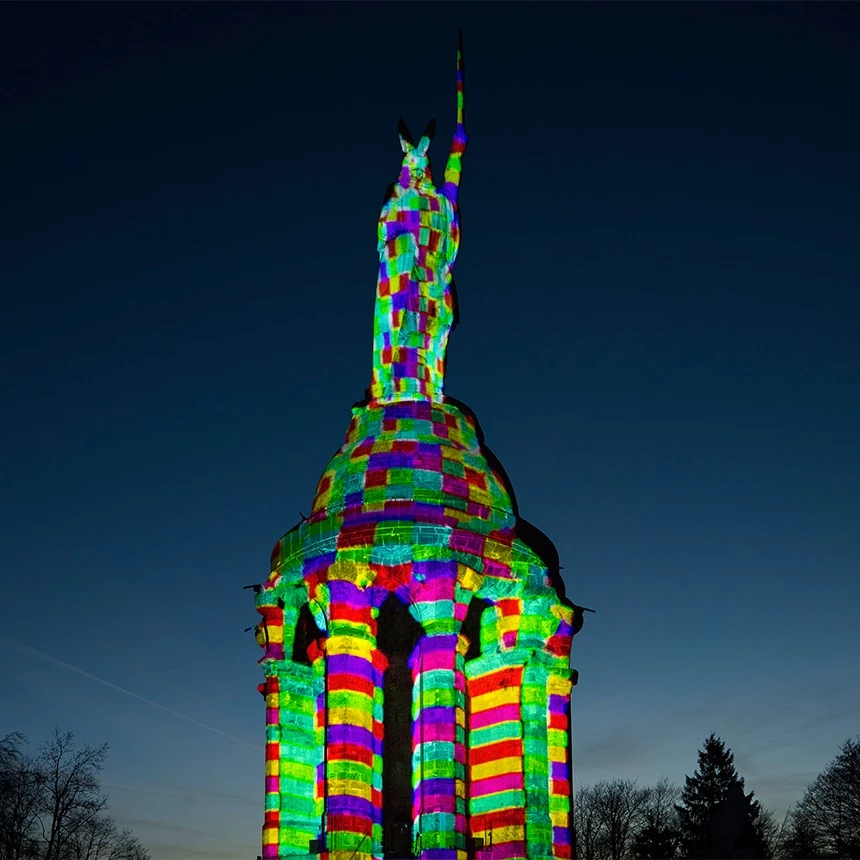 3D projection mapping on the Hermann monument shows the statue in a colorful grid look based on Atari