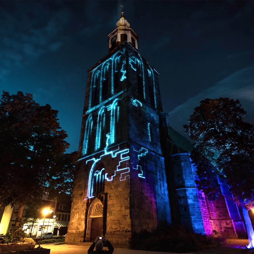 Facade elements traced with lines when projecting onto church on two sides of the building