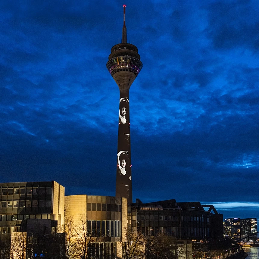 Depiction of a candidate from the 19th season of Germany's Next Top Model as projection mapping on the Rheinturm in Düsseldorf