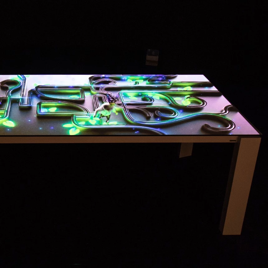 3d projection mapping on table surface at a furniture fair from Musterring shows magician in action