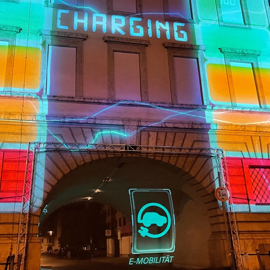 3D projection with holo effect seems to float in the air and shows the pictogram "E-mobility"