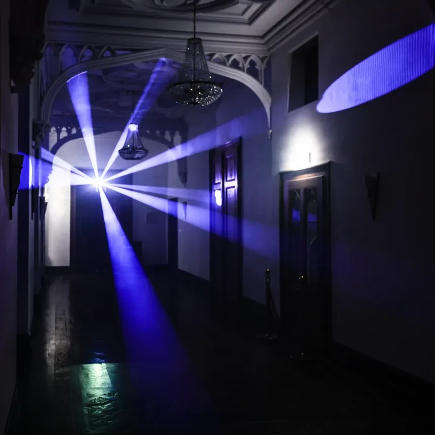 Blue laser beams illuminate a hallway inside Arenfels Castle