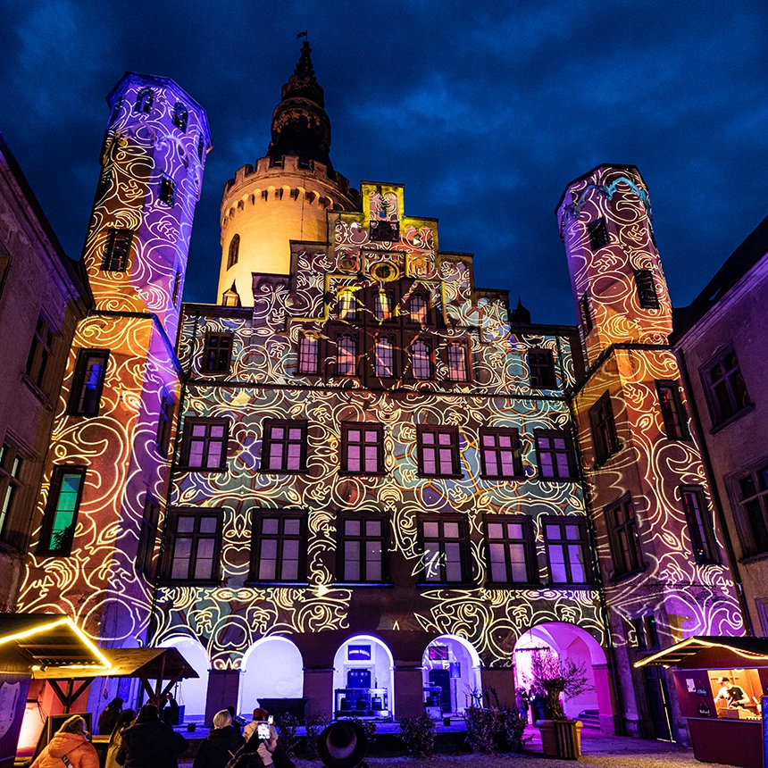 The historic facade of Arenfels Castle illuminated with flourishes