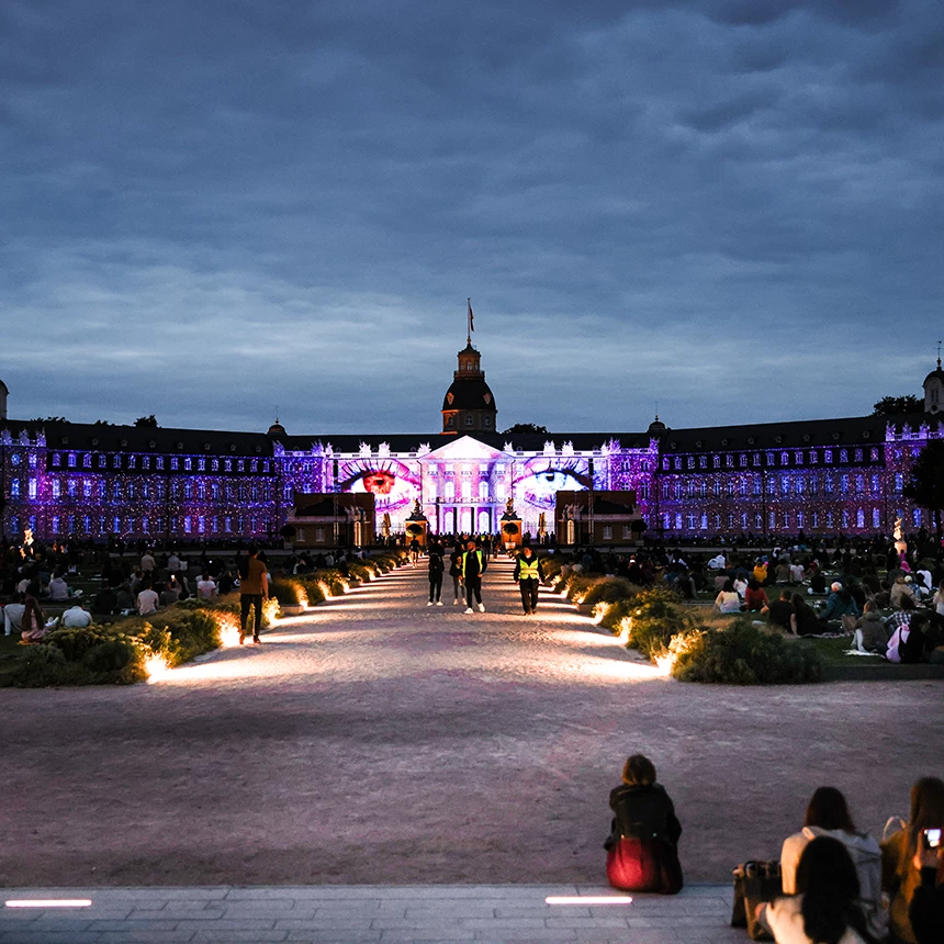 At the Light Festival, a pair of eyes can be seen on the wide facade of Karlsruhe Castle