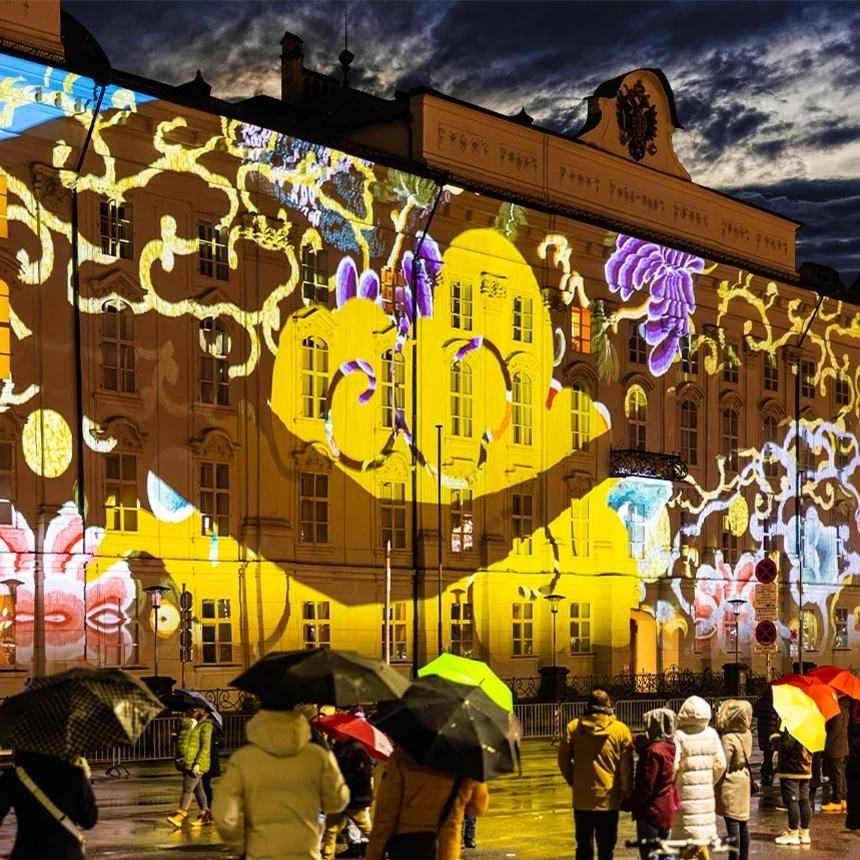 The facade of the Hofburg in Innsbruck appears in a new light with an illumination that shows colorful flowers and a dragon's tail