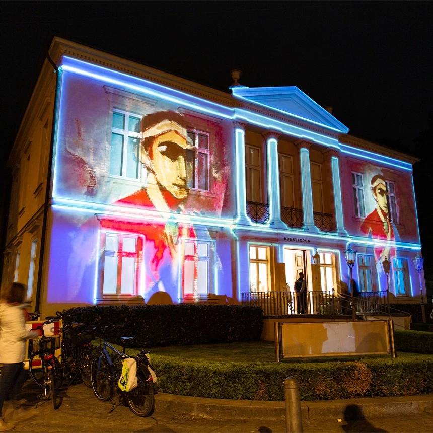 Static projection mapping shows painting of a man on buildings