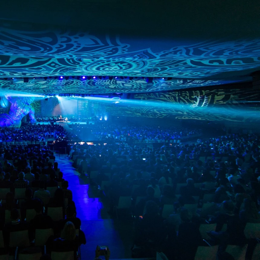 Panorama projection onto the walls and ceiling of a congress hall shows blue tribal patterns