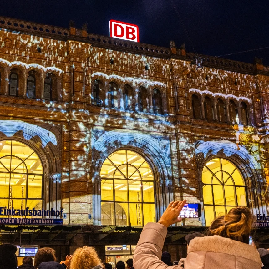 The audience of the Roncalli Christmas Village watches the Christmas 3D video show at the main train station in Hanover