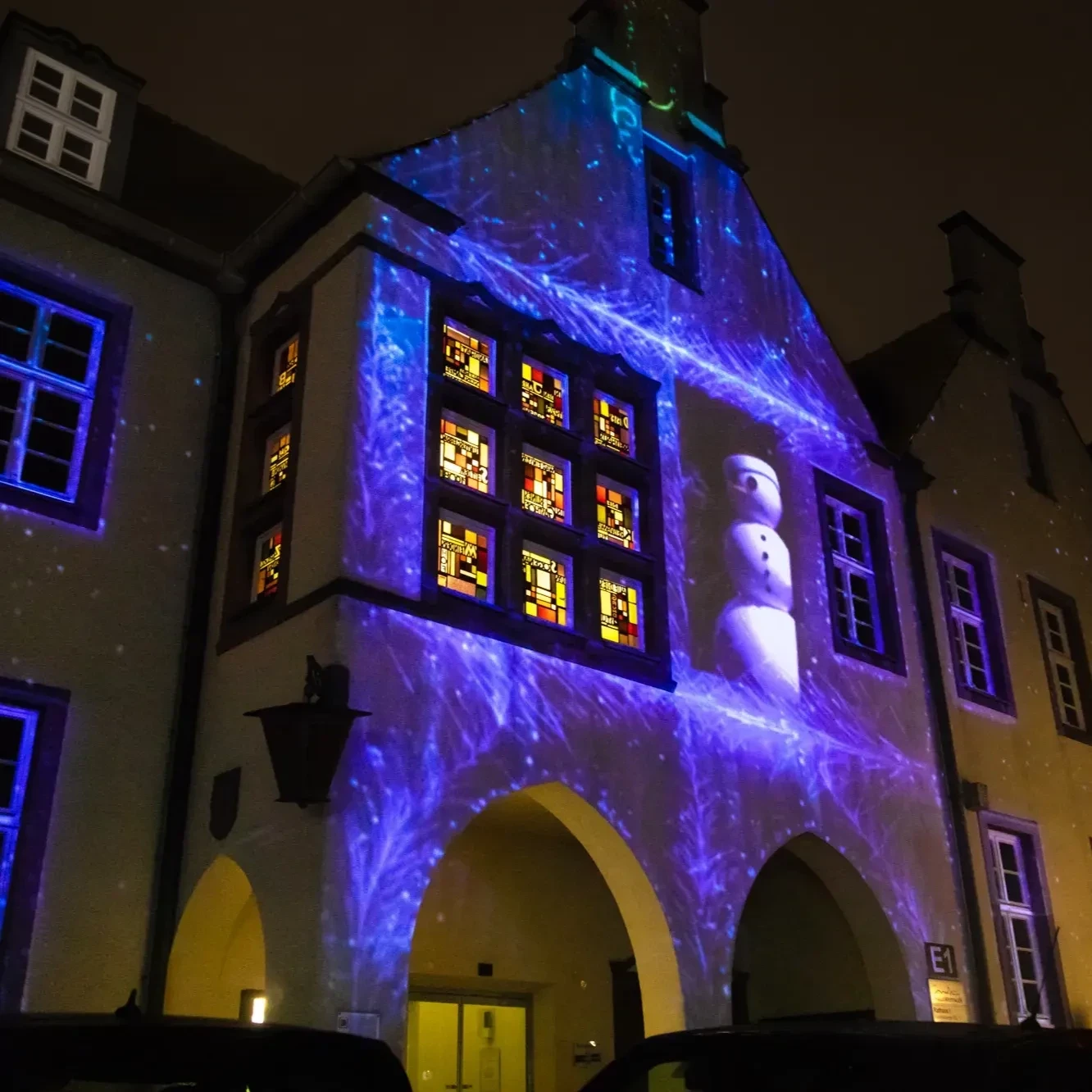 3D light show projection of a snowman in a snowstorm on the facade of the Halle Westfalen town hall