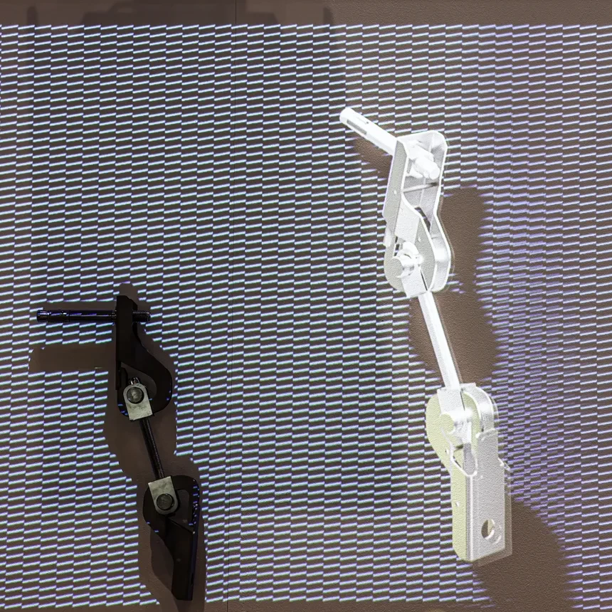 The functionality of a component attached to the wall is illustrated by the use of a projection