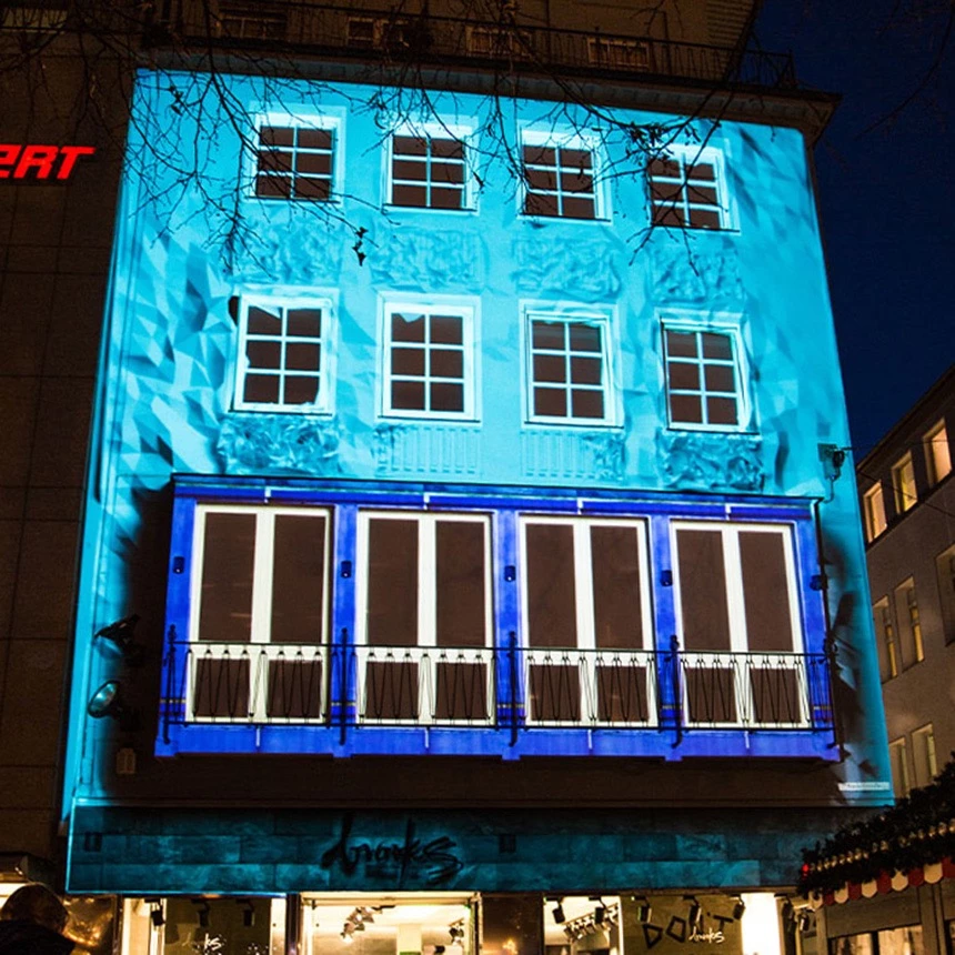 3D video mapping on the facade of the Brooks store in Bielefeld with turquoise effects during a guerrilla action