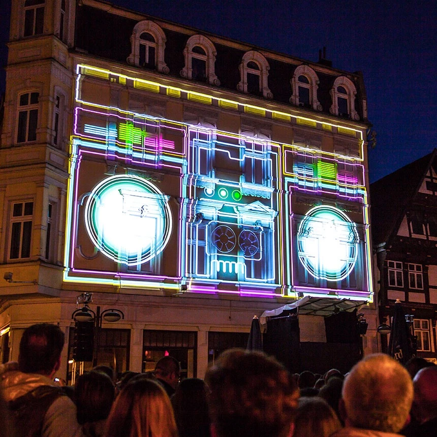 Video Mapping Show im Stil der 80er Jahre verwandelt Fassade in einen Ghettoblaster in Neon-Farben