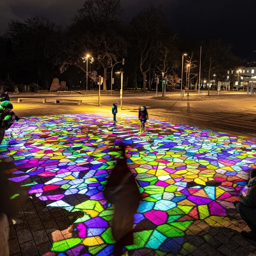 Interactive, colorful floor projection in downtown Wilhelmshaven with children playing