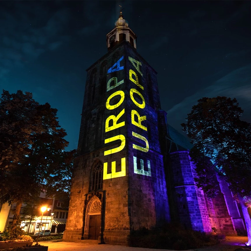 Tower Projection onto church tower in Nordhorn with lettering Europe in yellow and blue
