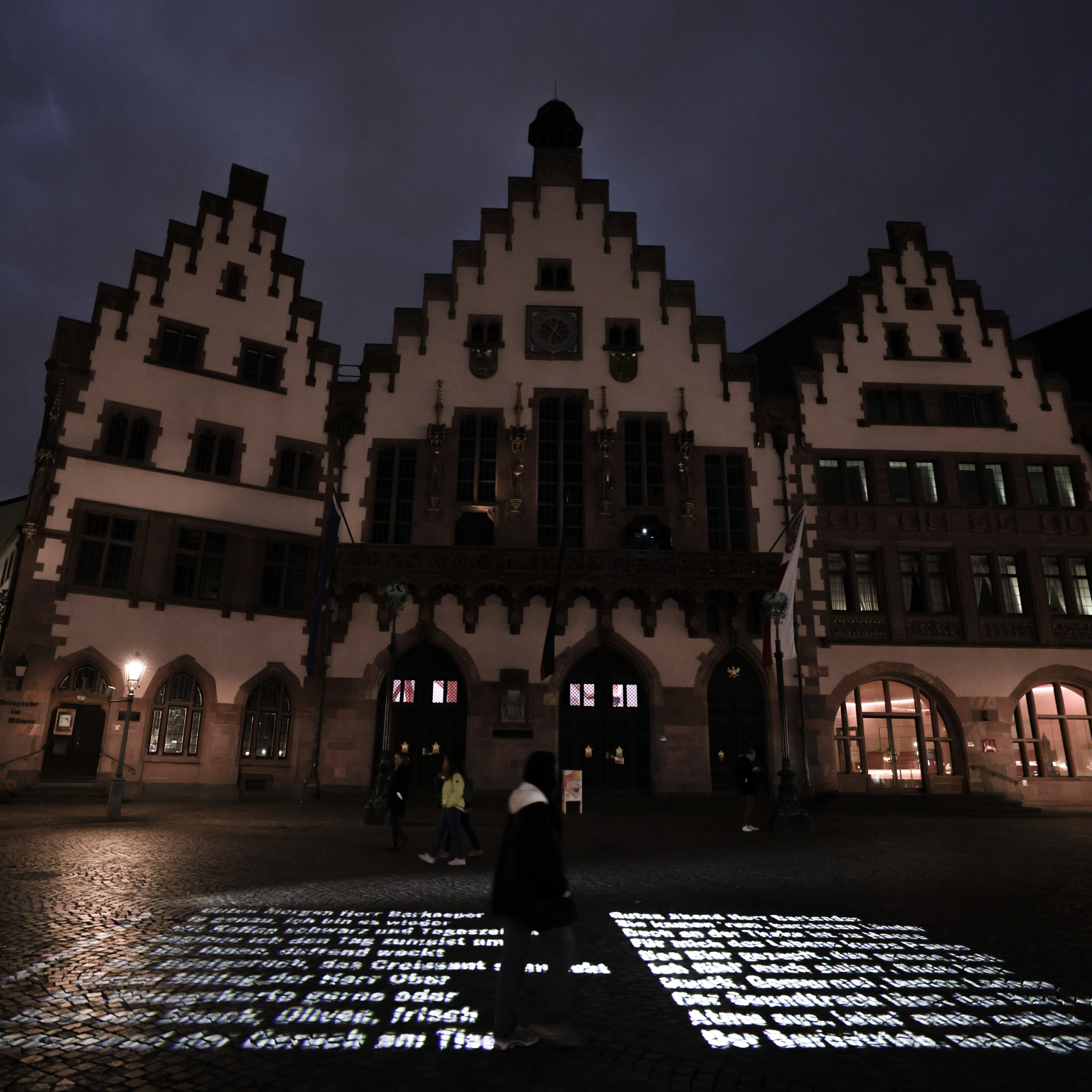 Floor projection of poem text on cobblestones of the Römerberg in Frankfurt