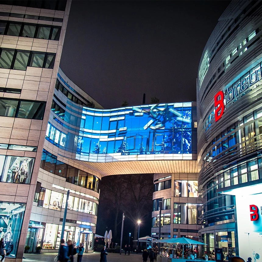 Video projection on glass surfaces, which were blinded by self-adhesive film: building-specific 3D effects let individual tiles move and a winter landscape behind them becomes visible