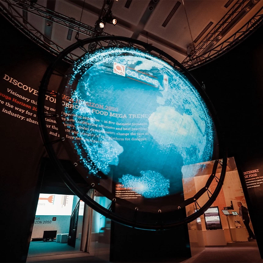 Holo mapping on an invisible circular screen shows a three-dimensional globe with the Anuga logo as an optical illusion for the Cologne trade fair