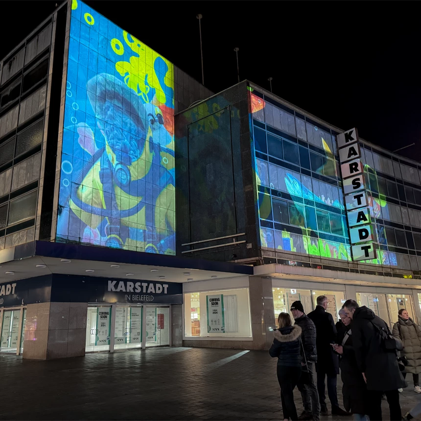 Facade projection in pop art style shows divers in deep sea environment