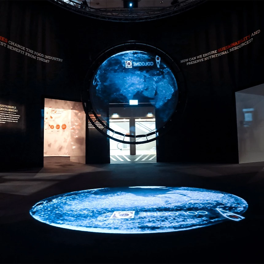 Projection of a globe onto a holo screen and floor in an exhibition room during Anuga in Cologne